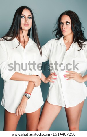 two sisters twins girl posing, making photo selfie, dressed same white shirt, diverse hairstyle friends, lifestyle people concept
