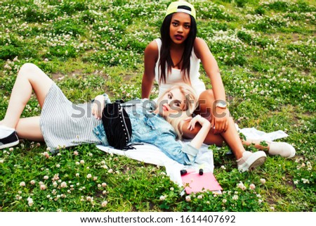 two young pretty teenager girls best friends laying on grass making selfie photo having fun, lifestyle happy people concept, students at summer