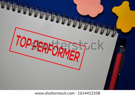 Top Performer write on a book isolated on blue background.
