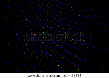 Neon lights in a disco. Isolated on black background, glare. night view, neon light, rays. Celebratory background. Blue and red lights star Rain