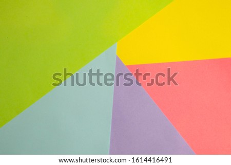 Flat lay design. Geometric shapes of paper in pink, green and yellow colors. 