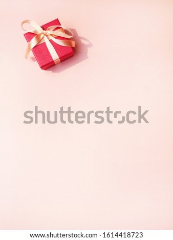 Gift box on pink background. Saint Valentine's day. vertical photo
