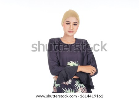 Closeup of a beautiful female Muslim model wearing black modern kurung, a modern urban lifestyle apparel for Muslim women isolated on white background. Beauty and fashion concept.