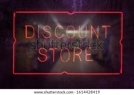 Discount Store Neon Sign in Rainy Window