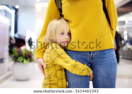 Little boy embrased his mother. Shyness, fears, anxiety. Hyper-attachment to mother. Royalty-Free Stock Photo #1614465343
