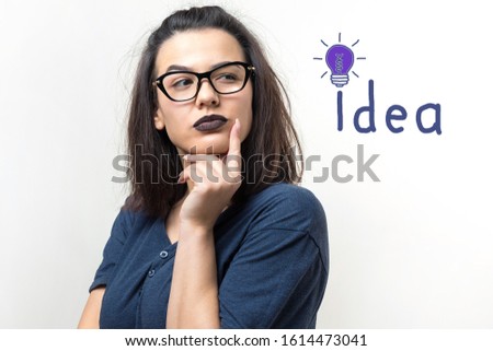 Illustration of an idea in the form of a light bulb drawn on the wall and a thinking girl over a business plan.