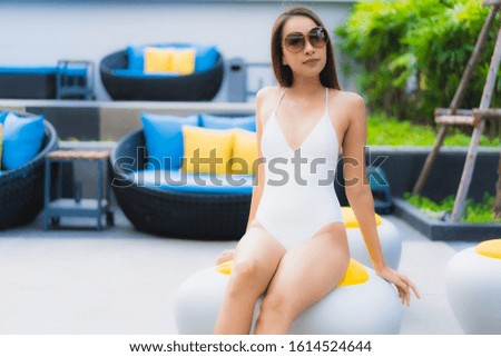 Portrait beautiful young asian women happy smile relax around outdoor swimming pool in hotel resort for travel vacation