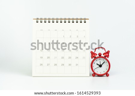 White clean calendar with red retro alarm clock on white background using as year plan, Busy work reminder, annual leave, project deadline or special event day concept.