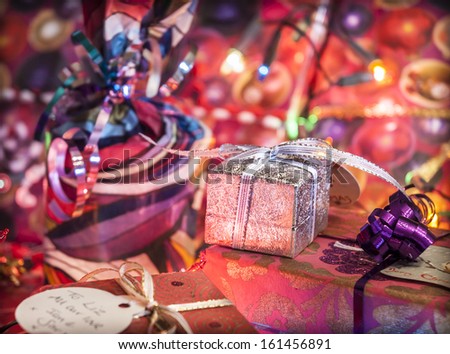 Christmas gifts wrapped with illuminated fairy lights.
