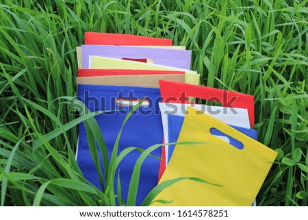 Non Woven Polypropylene Fabric Bags are growing in green agriculture field. amazing ECO Bags are about to be growing in the fertile soil. save earth concept with eco products. World Environment Day