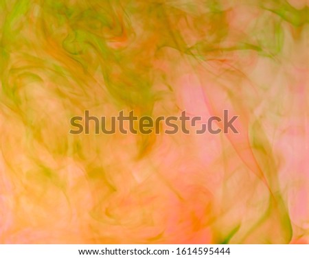 Blurred photo of food color drop and dissolve in water for background and texture concept.