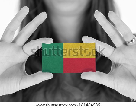 Woman showing a business card, black and white, Benin