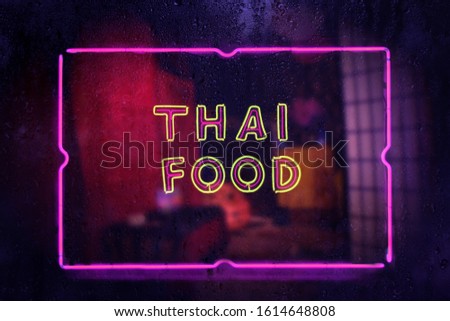 Neon Sign Thai Food in Rainy Window