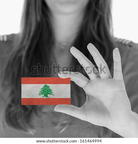 Woman showing a business card, black and white, Lebanon