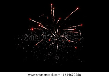 Silver with red shiny background of sparkles on black. New year concept. Firework.