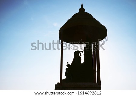 Silhouette of Shivaji statue, Raigad Fort Royalty-Free Stock Photo #1614692812
