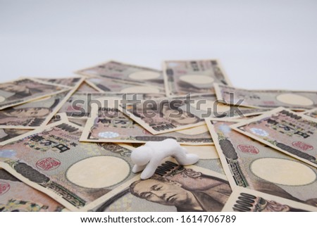 Concept image of loser in economic society. Loser who lost everything on the yen bill. Clay doll of white color and simple style. Horizontal position.
