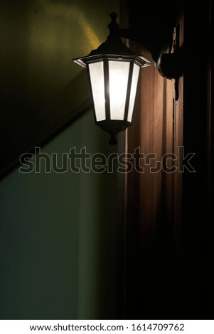 outdoor wall light lantern lit in the evening Parisian bar Paris France light
