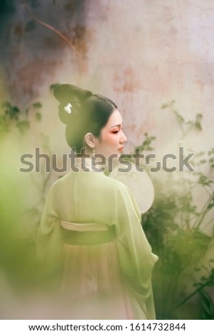 Woman dressed in Chinese ancient costumes like poetry and painting