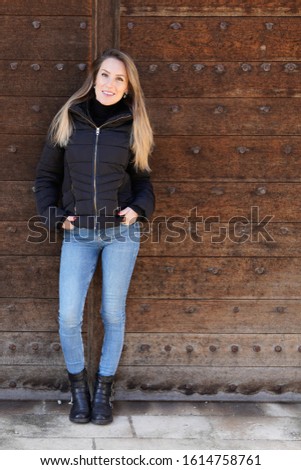 Girl wearing black jacket posing against street urban clothing style photography full beautiful blonde young woman slim 
