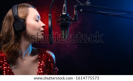 Vocalist sings in studio. Vocal and music, professional singing and skills.