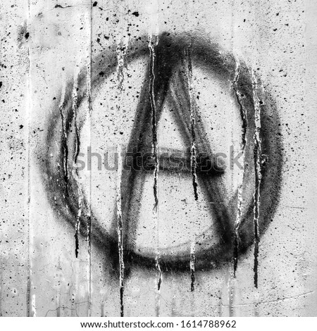 Symbol of Anarchy painted on a grungy concrete wall. Ideal for concepts and backgrounds.