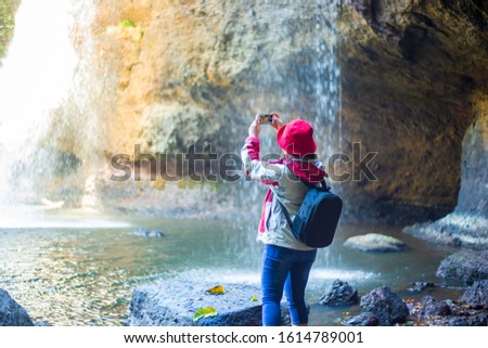 Young women, tourists, relax and take pictures in a beautiful natural view