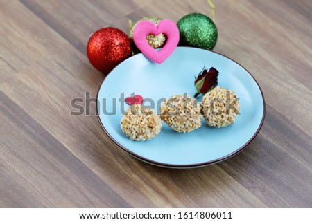 Sweet snacks, peanuts and chocolate for Valentine's Day or romancing time, selective focused picture of donuts covered with peanuts and sugar, love celebrations cookies or biscuits, for love one 
