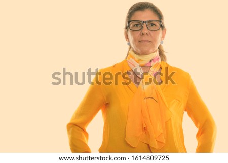 Studio shot of mature beautiful businesswoman wearing eyeglasses