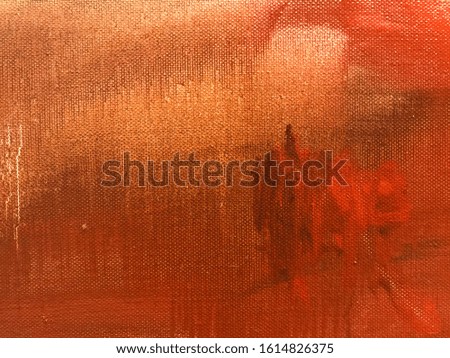Texture of faded red and orange cotton fabric with abstract black pencil marks. Image of a old shabby cloth clothes with stains closeup.