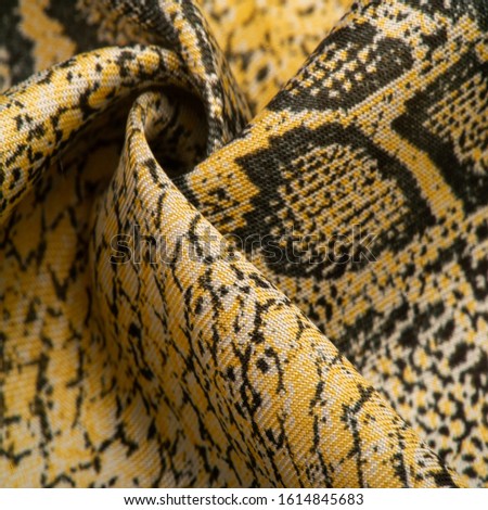 Texture, background, pattern, fabric with a pattern of yellow snake skin, African fabric, designer photo - safari in the country of Africa