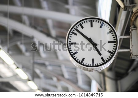 The clock shows the time on the skytrain station Royalty-Free Stock Photo #1614849715