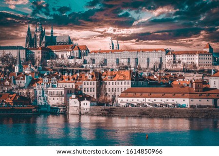 The old town of Prague. View over river Vltava with Saint Vitus cathedral on the skyline.Prague architecture and city on a cloudy day. 