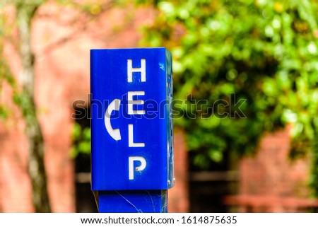 A blue emergency phone box labeled "HELP" at a university campus in Melbourne, Australia.