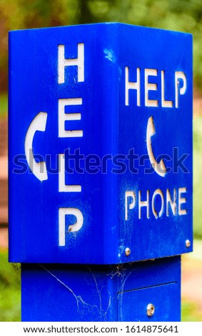 A blue emergency phone box labeled "HELP" at a university campus in Melbourne, Australia.