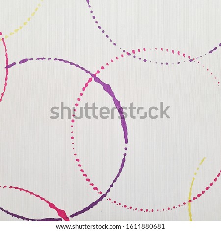 White ceramic tile with multicolor circle pattern for wall decor. Concrete stone surface background. Texture for interior design project.