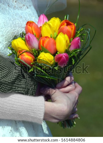 Wedding spring bouquet, tulips. Bunch of flowers in hand.