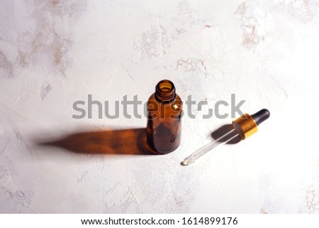Vial of face serum for women. Beauty concept. High contrast Royalty-Free Stock Photo #1614899176