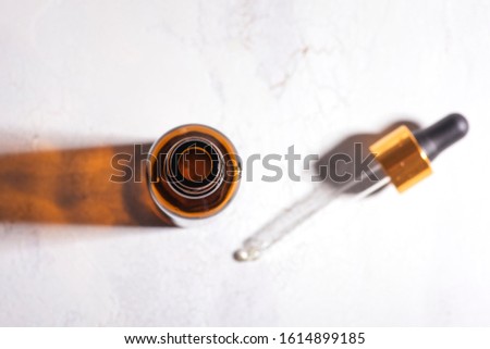 Vial of face serum for women. Beauty concept. High contrast Royalty-Free Stock Photo #1614899185