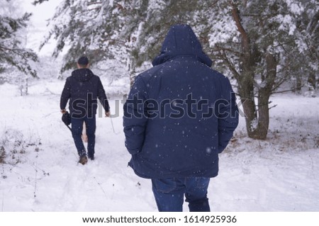 people in a snowy forest