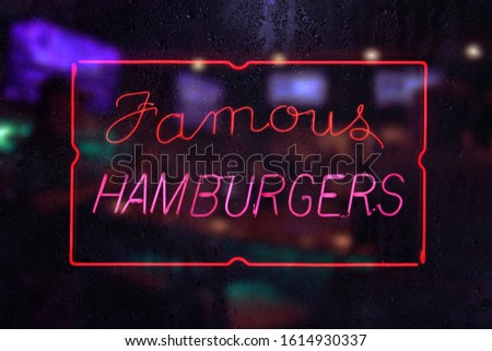 Famous Hamburgers Sign in Rainy Window