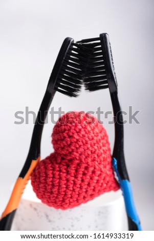 Creative image with two toothbrushes and heart between them. Love concept Royalty-Free Stock Photo #1614933319