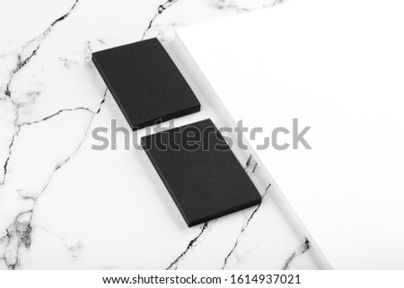 Photo of black & white branding identity mock up on white marble. Template isolated on marble background. For graphic designers presentations and portfolios marble premium luxury mock-up