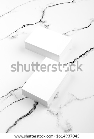 Photo of white business cards on white marble. Template for branding identity isolated on marble background.  Marble premium luxury mock-up. Business Card isolated on marble stone. 