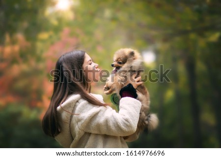 Sunny day and girl with dog in the park, Odessa
