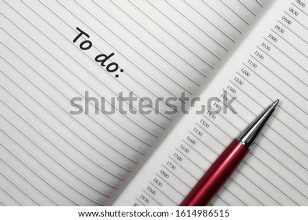 Text to do on notebook with red pen on white background. Top view with copy space for input the text.
