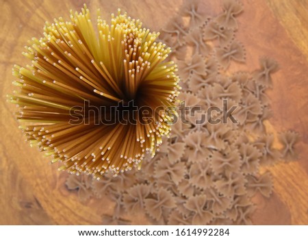 Dried spaghetti pasta on wooden background stock images. Spaghetti on the table top view. Pasta on wooden background stock images