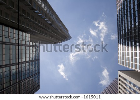 Picture taken from looking directly up into the sky between tall buildings