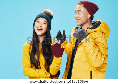 Young couple fashion studio luxury winter blue isolated background