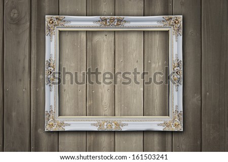 wooden photo frame on old wooden wall  